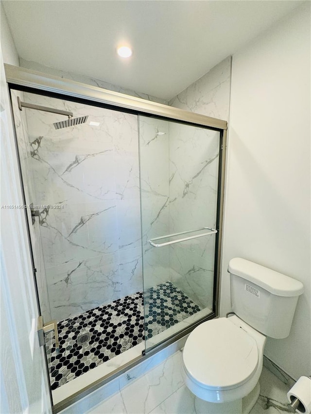 bathroom with toilet and an enclosed shower