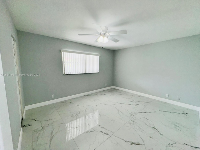 unfurnished room with ceiling fan