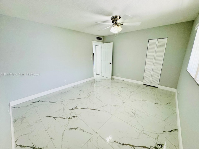 unfurnished bedroom featuring a closet and ceiling fan