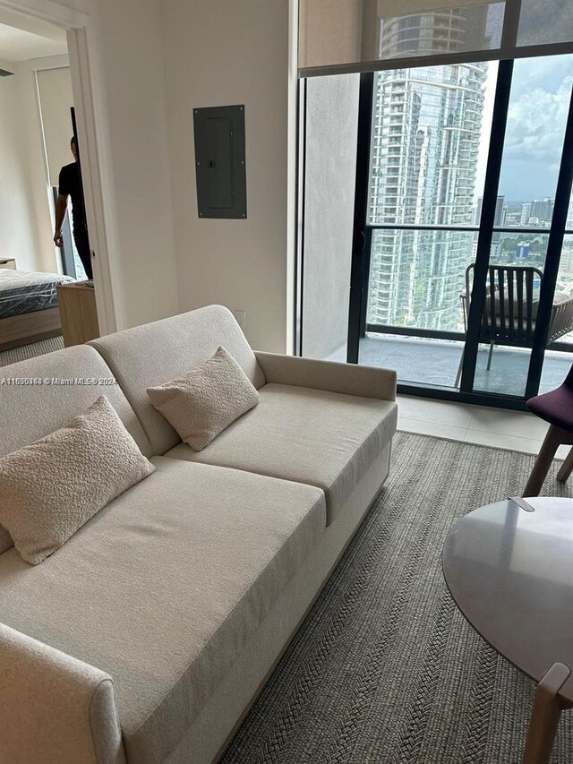 living room featuring electric panel and tile patterned floors