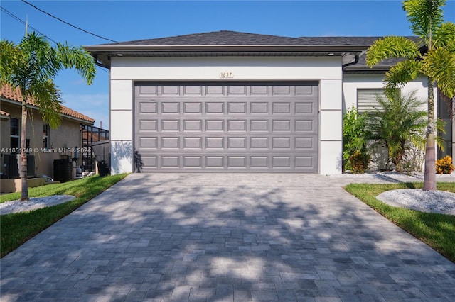 exterior space with cooling unit and a garage