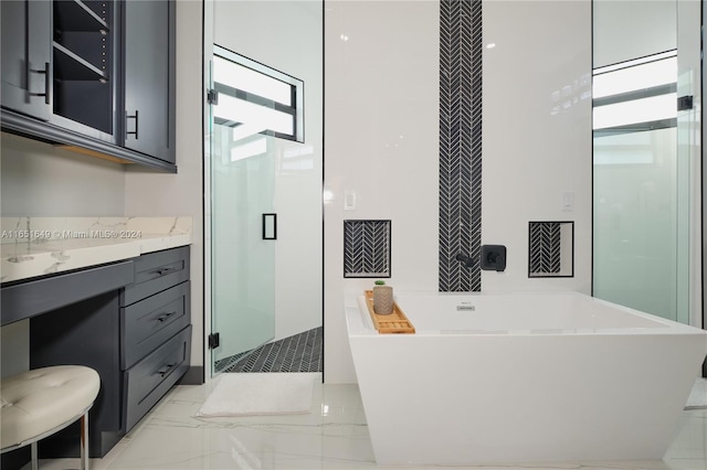 bathroom with vanity and separate shower and tub