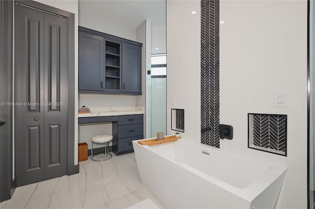 bathroom with vanity and a washtub