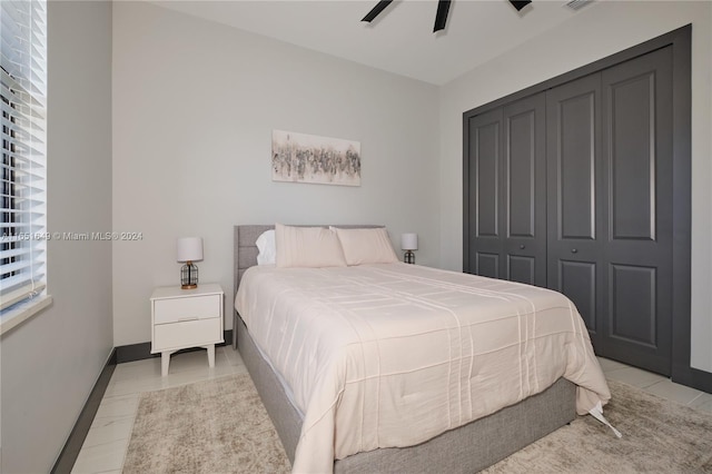 bedroom with ceiling fan and a closet