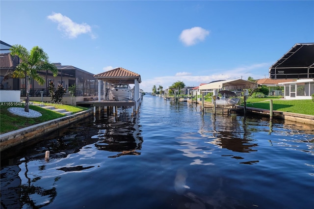 dock area with a water view and a yard