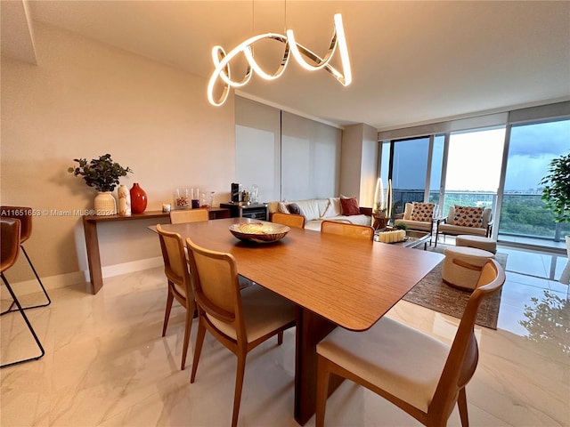 dining space with expansive windows and an inviting chandelier