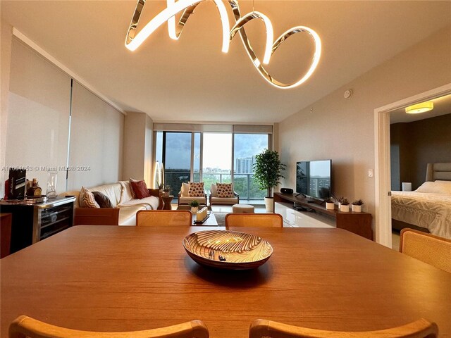 dining room featuring a notable chandelier and expansive windows