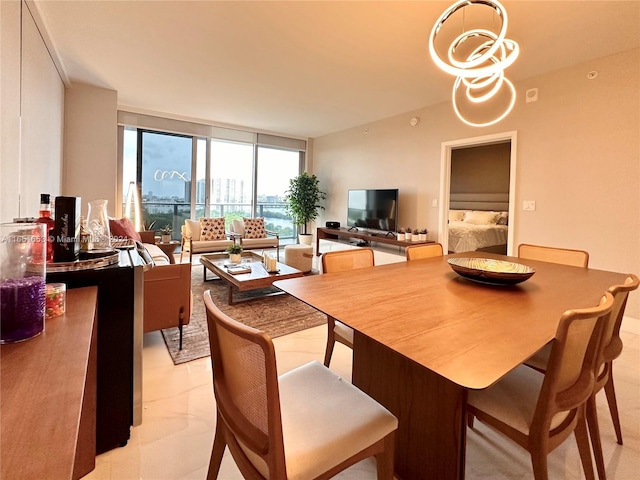 dining area with floor to ceiling windows and an inviting chandelier