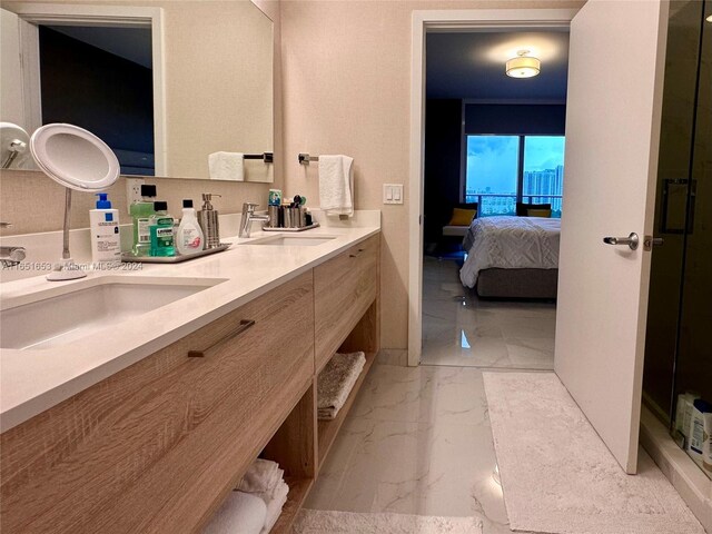 bathroom featuring vanity and a shower with door