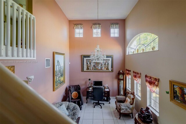 interior space with plenty of natural light, a chandelier, and light tile patterned flooring