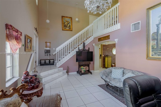 living room with an inviting chandelier, a high ceiling, and light tile patterned flooring