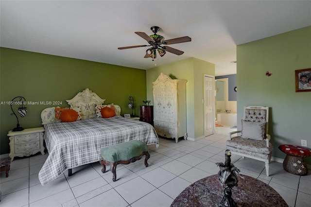 tiled bedroom featuring ensuite bathroom, ceiling fan, and a closet