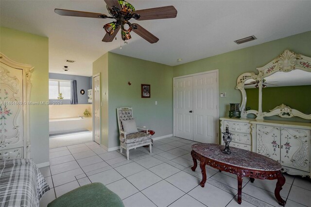 interior space with ceiling fan and light tile patterned floors