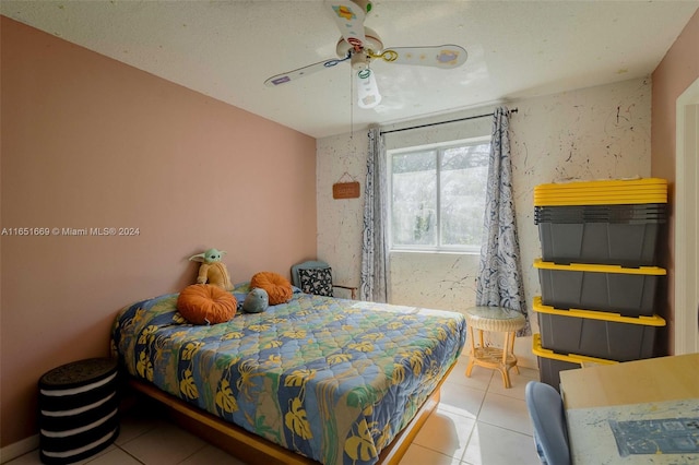 bedroom featuring a textured ceiling, ceiling fan, and tile patterned floors