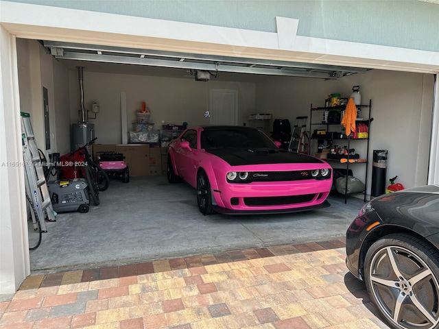 garage with gas water heater and a garage door opener