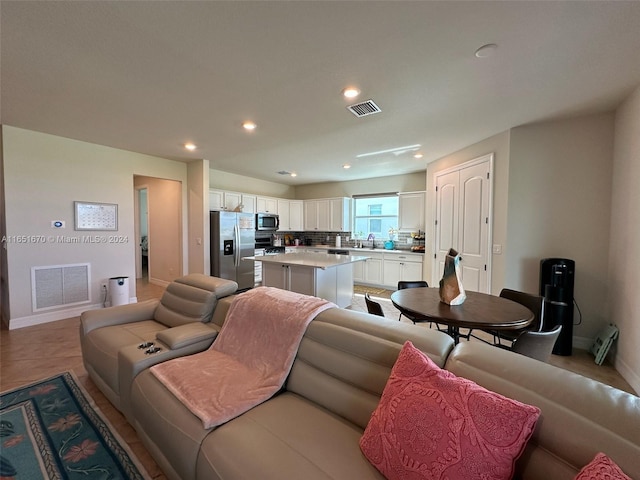 living room with sink and tile patterned floors