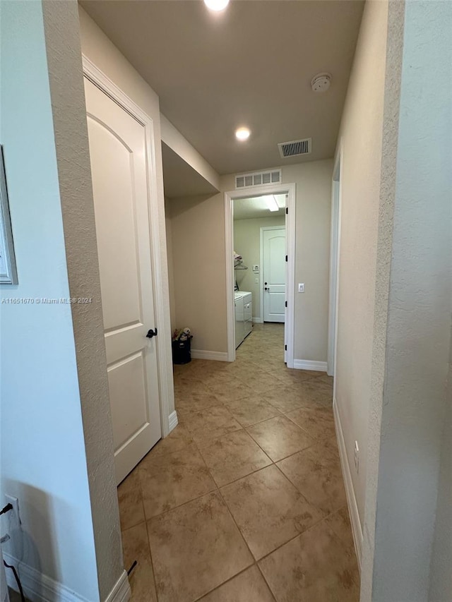 hall with light tile patterned floors