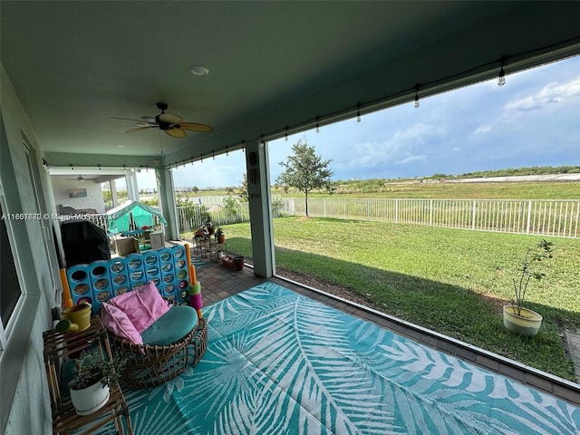 sunroom featuring ceiling fan