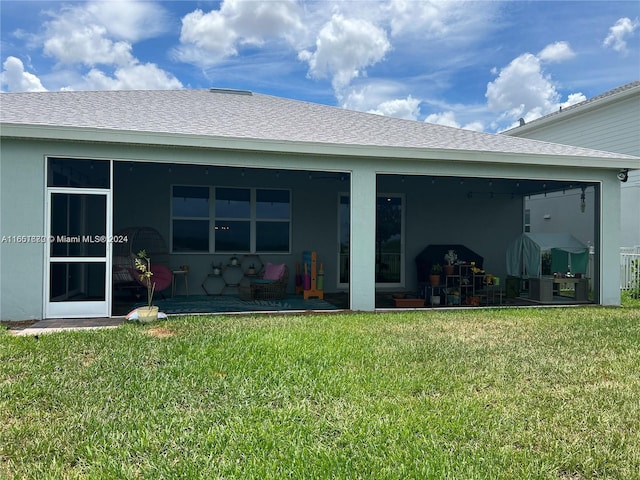 rear view of house featuring a patio area and a yard