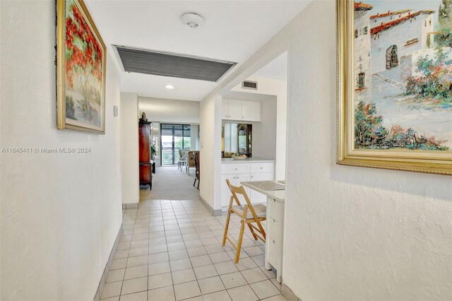 hall featuring light tile patterned floors