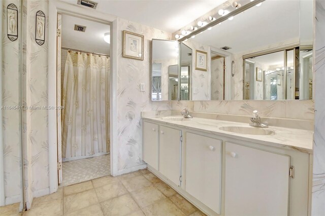 bathroom featuring vanity and a shower with shower curtain