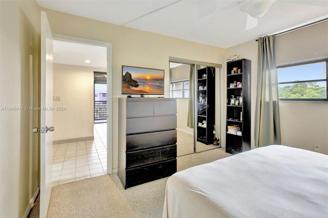 carpeted bedroom featuring a closet and ceiling fan