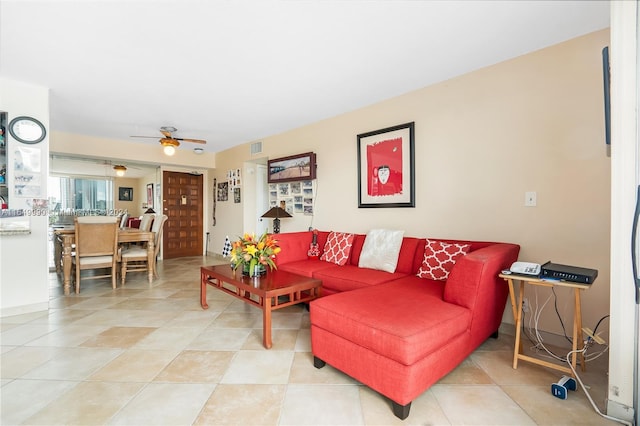 tiled living room with ceiling fan