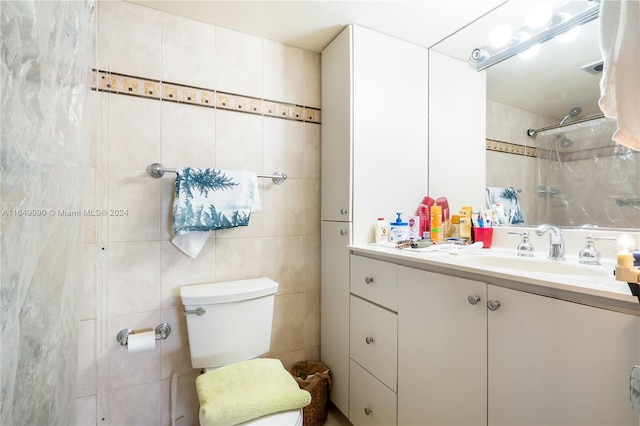 bathroom with a shower, tile walls, toilet, and vanity