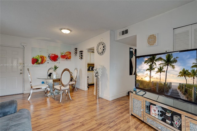 interior space featuring a textured ceiling and light hardwood / wood-style floors