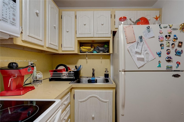 kitchen featuring white appliances and sink