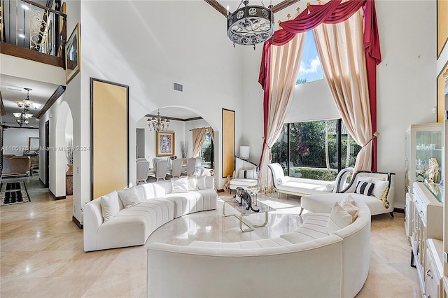 living room featuring crown molding, a high ceiling, and a notable chandelier