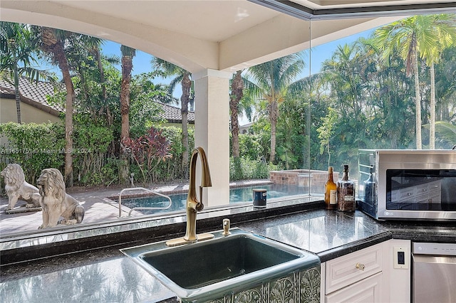 kitchen featuring white cabinetry, sink, and stainless steel appliances