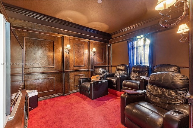 cinema room featuring wood walls, a textured ceiling, carpet floors, and crown molding