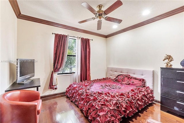 bedroom with wood-type flooring, ornamental molding, and ceiling fan