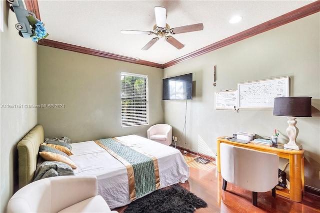 bedroom featuring a textured ceiling, wood-type flooring, crown molding, and ceiling fan