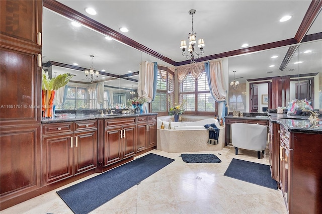 bathroom featuring crown molding, a bathing tub, vanity, and a notable chandelier