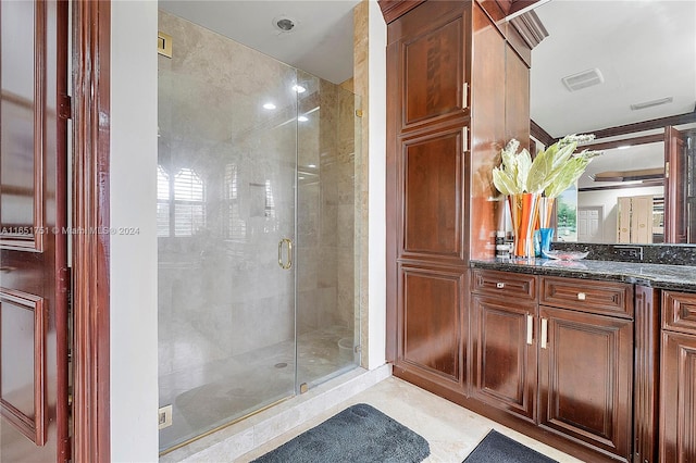 bathroom with vanity and an enclosed shower