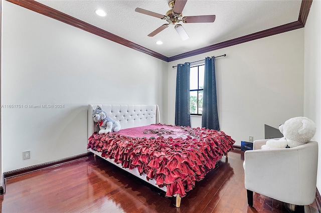 bedroom featuring ornamental molding, hardwood / wood-style floors, a textured ceiling, and ceiling fan