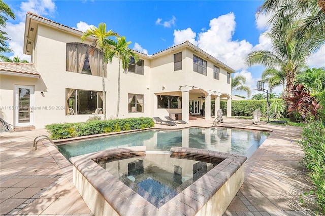 view of swimming pool with a patio and an in ground hot tub