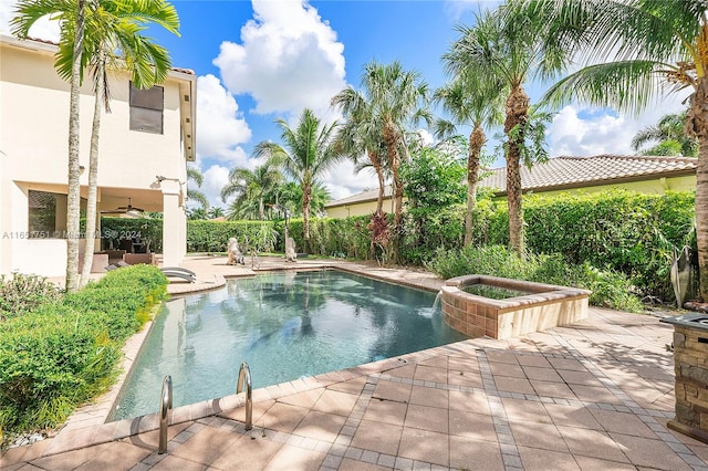 view of pool with ceiling fan, a patio area, and pool water feature