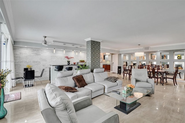 living room with ornamental molding and ceiling fan