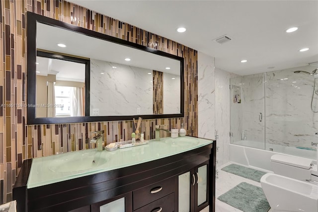 full bathroom featuring tiled shower / bath, toilet, tile walls, a bidet, and vanity