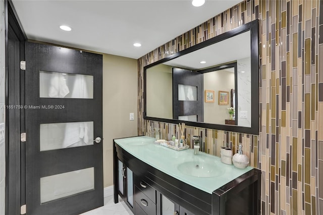 bathroom with tile patterned flooring, vanity, and tasteful backsplash