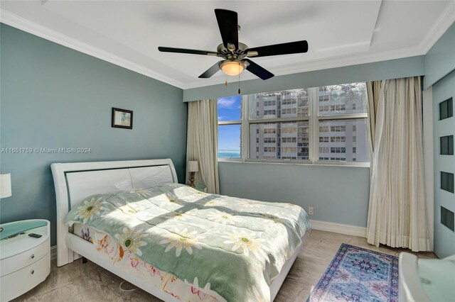 bedroom featuring ceiling fan and ornamental molding