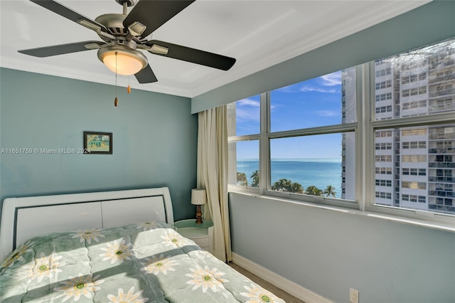 1880 S Ocean Dr Unit Ts106, Hallandale Beach, FL 33009 - bedroom with baseboards, a water view, ornamental molding, and a ceiling fan