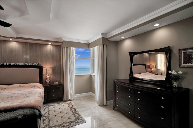 bedroom featuring crown molding and a water view