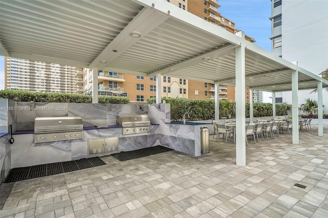 1880 S Ocean Dr Unit Ts106, Hallandale Beach, FL 33009 - view of patio with a grill, outdoor dining area, exterior kitchen, and a sink