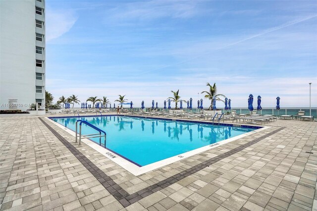 view of swimming pool with a water view