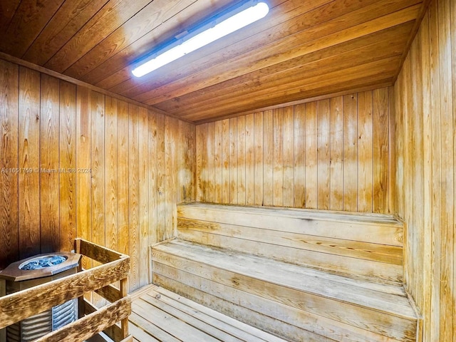 view of sauna / steam room with wooden walls and wooden ceiling