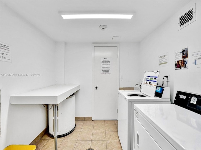 1880 S Ocean Dr Unit Ts106, Hallandale Beach, FL 33009 - common laundry area featuring washing machine and dryer, visible vents, and light tile patterned floors